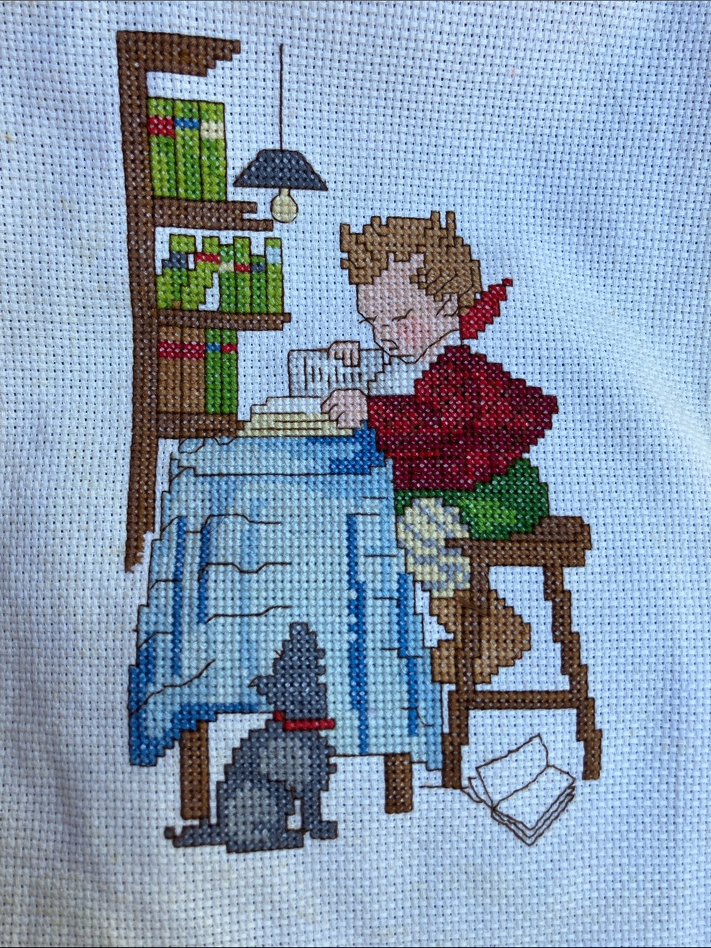 Counted cross stitch picture of boy reading books with dog 90’s
